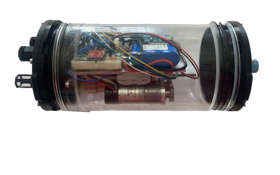 Actual laboratory DepthPod prototype with a transparent cylindrical housing and visible internal mechanism